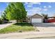 Single-Gathering home with a spacious front yard and two-car garage with a long driveway at 1115 Cherry Ct, Fort Lupton, CO 80621