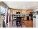 Open kitchen and dining area featuring wood cabinets, stainless steel appliances, and backyard access at 1115 Cherry Ct, Fort Lupton, CO 80621