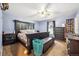 Serene bedroom with dark furniture, carpet flooring, ceiling fan and ample space at 1115 Cherry Ct, Fort Lupton, CO 80621