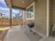 Backyard patio with a grill set up and seating next to window at 9844 Truckee St, Commerce City, CO 80022