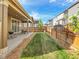 Cozy backyard featuring a covered patio, grill, and well-maintained lawn, perfect for outdoor relaxation and entertaining at 9844 Truckee St, Commerce City, CO 80022