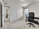 Bright room with office setup, and door to what could be a spare bedroom at 9844 Truckee St, Commerce City, CO 80022