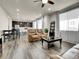 Large and open living area with dining area, lots of natural light, and sleek flooring at 9844 Truckee St, Commerce City, CO 80022
