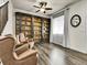 Spacious living room with hardwood floors, custom bookshelves, and neutral décor at 9844 Truckee St, Commerce City, CO 80022