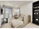 Open loft space with a comfortable sectional, mounted TV, built-in bookshelf and natural light at 9844 Truckee St, Commerce City, CO 80022