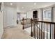 Bright upstairs loft featuring neutral carpeting, modern lighting, and a cozy living area with elegant decor at 9844 Truckee St, Commerce City, CO 80022