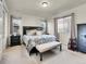 Spacious main bedroom with a decorative bed frame, bench seating, and windows for natural light at 9844 Truckee St, Commerce City, CO 80022