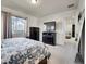 Bright and airy main bedroom with dark wood accents, tv and comfortable window lighting at 9844 Truckee St, Commerce City, CO 80022