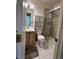 Modern bathroom featuring a glass enclosed shower and ample vanity storage at 1878 S Cole St, Lakewood, CO 80228