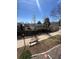 Beautiful community featuring a paved sidewalk with mature trees and lush landscaping on a bright sunny day at 1878 S Cole St, Lakewood, CO 80228