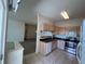 Well-lit kitchen featuring stainless steel appliances, granite countertops, and tile flooring at 1878 S Cole St, Lakewood, CO 80228