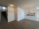 Open-concept living area with stairway, closet and pass-through to kitchen at 1878 S Cole St, Lakewood, CO 80228