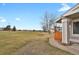 Lush backyard view highlighting the grassy expanse, mature trees and the home's proximity to the golf course at 8755 Chase Dr # 167, Arvada, CO 80003