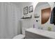 Chic bathroom with a modern sink, toilet, and a black and white shower curtain at 8755 Chase Dr # 167, Arvada, CO 80003
