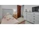 Comfortable bedroom with a plush unicorn and white-washed wood furnishings at 8755 Chase Dr # 167, Arvada, CO 80003