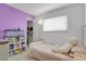 Cozy bedroom featuring a plush unicorn, built-in bookcase and a pink wall at 8755 Chase Dr # 167, Arvada, CO 80003