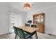 Bright dining area featuring a wooden table, green chairs, and a classic china cabinet at 8755 Chase Dr # 167, Arvada, CO 80003