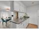 Bright kitchen featuring white cabinets, a gray countertop, and stainless steel sink at 8755 Chase Dr # 167, Arvada, CO 80003