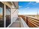 Private balcony with sliding glass door and wooden railing, perfect for enjoying the outdoors at 3282 N Catawba Way, Aurora, CO 80019