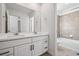 Bright bathroom featuring a double sink vanity, large mirror, and tile flooring at 3282 N Catawba Way, Aurora, CO 80019