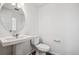 Bathroom featuring a pedestal sink, toilet, and neutral color palette at 3282 N Catawba Way, Aurora, CO 80019
