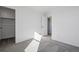 Bedroom featuring neutral carpet, closet, and door to the hallway at 3282 N Catawba Way, Aurora, CO 80019