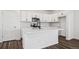 Modern kitchen featuring an island with black faucet and stainless steel appliances at 3282 N Catawba Way, Aurora, CO 80019
