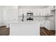 Modern kitchen featuring white cabinetry, stainless steel appliances, and quartz countertops at 3282 N Catawba Way, Aurora, CO 80019