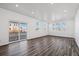 Bright living room with wood flooring, large windows, and a sliding glass door to the backyard at 3282 N Catawba Way, Aurora, CO 80019