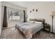 Comfortable bedroom with large window and carpeted floors at 5455 S Dover St # 101, Littleton, CO 80123