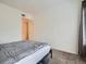 Neutral bedroom with gray bedspread, side tables, and great natural light at 5455 S Dover St # 101, Littleton, CO 80123