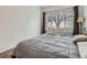 Comfortable bedroom with large window and carpeted floors at 5455 S Dover St # 101, Littleton, CO 80123