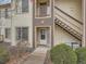 Charming condo entrance with stairs, featuring neutral siding and well-maintained landscaping at 5455 S Dover St # 101, Littleton, CO 80123