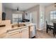Kitchen with marble countertops, stainless dishwasher and sink, that opens up to the dining and living areas at 5455 S Dover St # 101, Littleton, CO 80123
