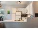 Bright kitchen featuring white cabinets, stainless sink, and modern appliances at 5455 S Dover St # 101, Littleton, CO 80123