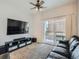 Relaxing living room with sliding door, comfortable couch, ceiling fan and entertainment center at 5455 S Dover St # 101, Littleton, CO 80123