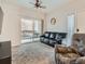 Comfortable living room with a sliding glass door to a balcony, ceiling fan, and neutral decor at 5455 S Dover St # 101, Littleton, CO 80123