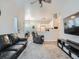 Open-concept living area with tv, kitchen, and dining area, filled with natural light and cozy furnishings at 5455 S Dover St # 101, Littleton, CO 80123