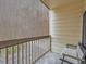 This patio features wood railings and a seated bench at 5455 S Dover St # 101, Littleton, CO 80123