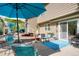 Outdoor patio with comfortable seating, dining area, and vibrant blue accents, perfect for entertaining at 7344 S Sheephorn Mtn, Littleton, CO 80127