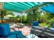Inviting back patio with a pergola, string lights, and comfortable seating surrounded by a lush green yard at 7344 S Sheephorn Mtn, Littleton, CO 80127