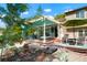Backyard patio featuring a pergola, outdoor seating, rock garden, and lush greenery at 7344 S Sheephorn Mtn, Littleton, CO 80127