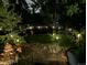 This backyard provides tranquility with the landscape lighting, trees and shrubbery at 7344 S Sheephorn Mtn, Littleton, CO 80127