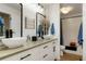Bright bathroom featuring double sinks, modern fixtures, and a tiled shower/tub combo for convenience at 7344 S Sheephorn Mtn, Littleton, CO 80127
