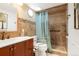 Well-maintained bathroom with a walk-in shower, safety bar, and neutral tiling at 7344 S Sheephorn Mtn, Littleton, CO 80127