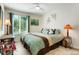 Bright bedroom features a queen-sized bed, a ceiling fan and lots of natural light at 7344 S Sheephorn Mtn, Littleton, CO 80127