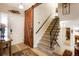 Inviting entryway with stylish barn door, hardwood floors, and staircase leading to the upper level at 7344 S Sheephorn Mtn, Littleton, CO 80127