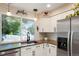 Modern kitchen featuring stainless steel appliances, and bright white cabinetry, perfect for cooking at 7344 S Sheephorn Mtn, Littleton, CO 80127
