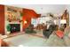 Open-concept living room featuring a stone fireplace, comfortable seating, and bright, inviting decor at 7344 S Sheephorn Mtn, Littleton, CO 80127