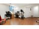 Versatile basement space featuring a home office setup with multiple desks and exercise equipment at 7344 S Sheephorn Mtn, Littleton, CO 80127